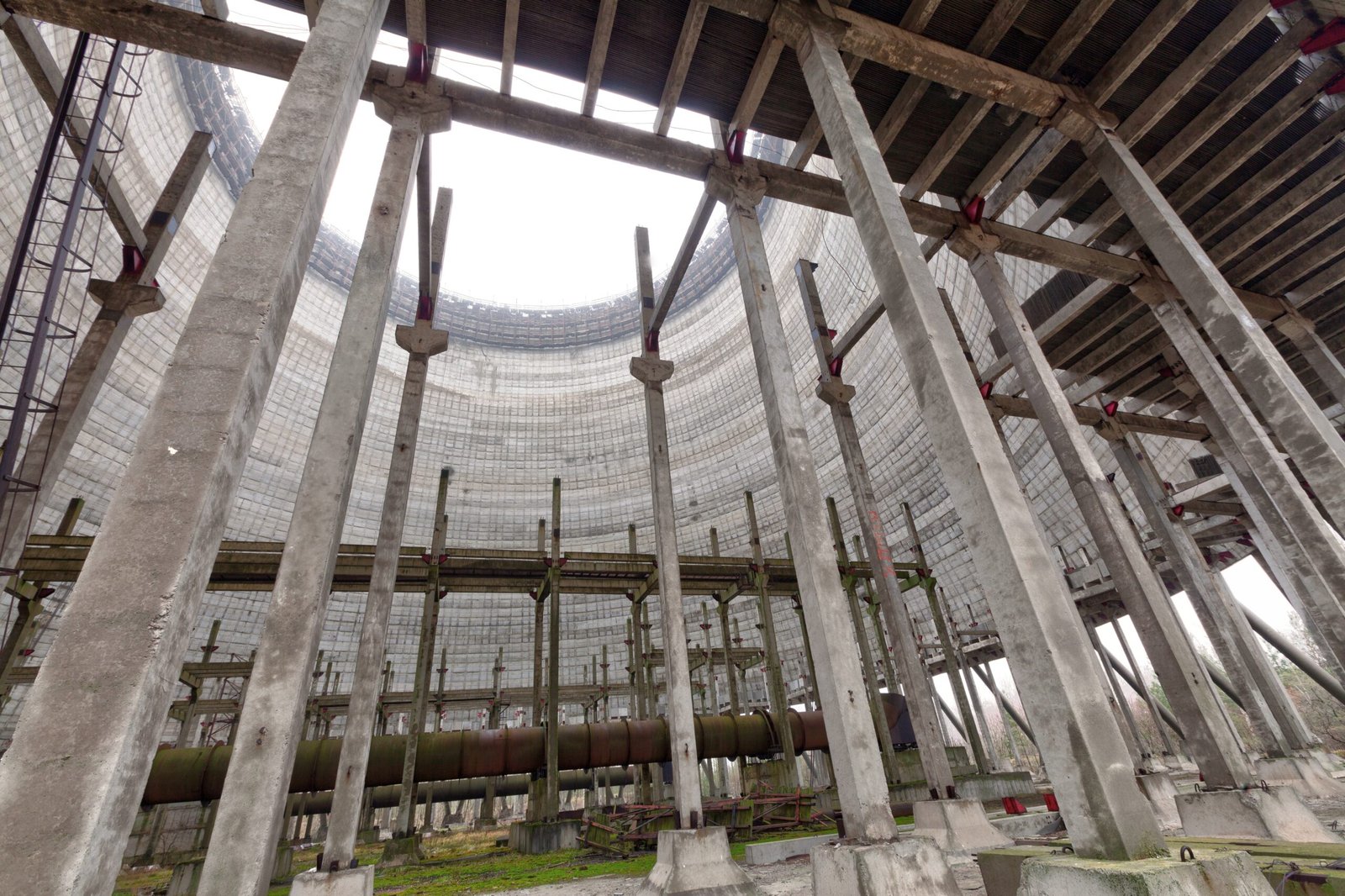 Inside view of a cooling tower under construction with scaffolding and concrete columns