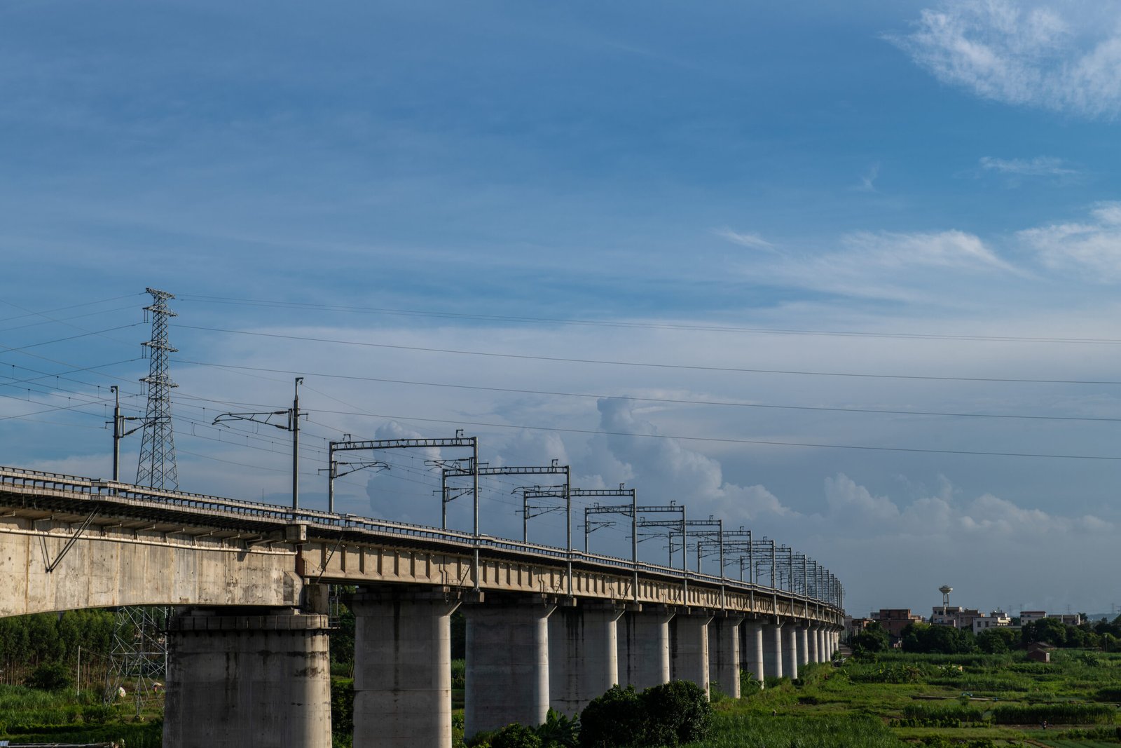 Elevated HSR viaduct across fields with contact line masts