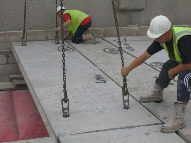 worker lifting a thin GFRC panel