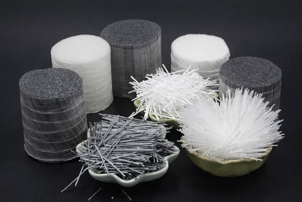 Several long polypropylene macro fibers show textured and deformed profiles designed for better bond.