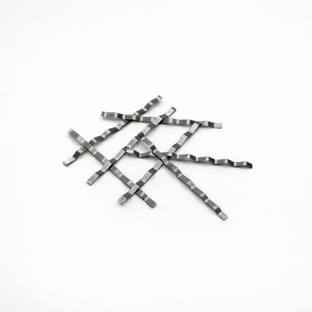 Flat crimped steel fiber strips arranged on a light gray background for reinforced concrete applications
