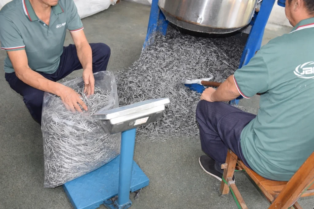 Cut polypropylene concrete fibers being measured and checked in a quality control lab