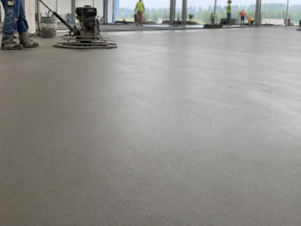A finished microfiber cement floor surface shows a smooth texture with reduced visible cracking.